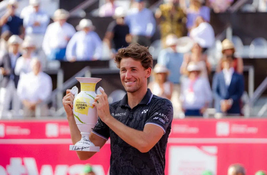 Casper Ruud a preparar uma pancada de direita em terra batida no Millennium Estoril Open, com a inscrição “Estoril” visível no court.