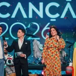 Artistas e apresentadores em palco durante a primeira semifinal do Festival da Canção 2026, transmitida pela RTP, com os finalistas reunidos sob o logótipo do evento.