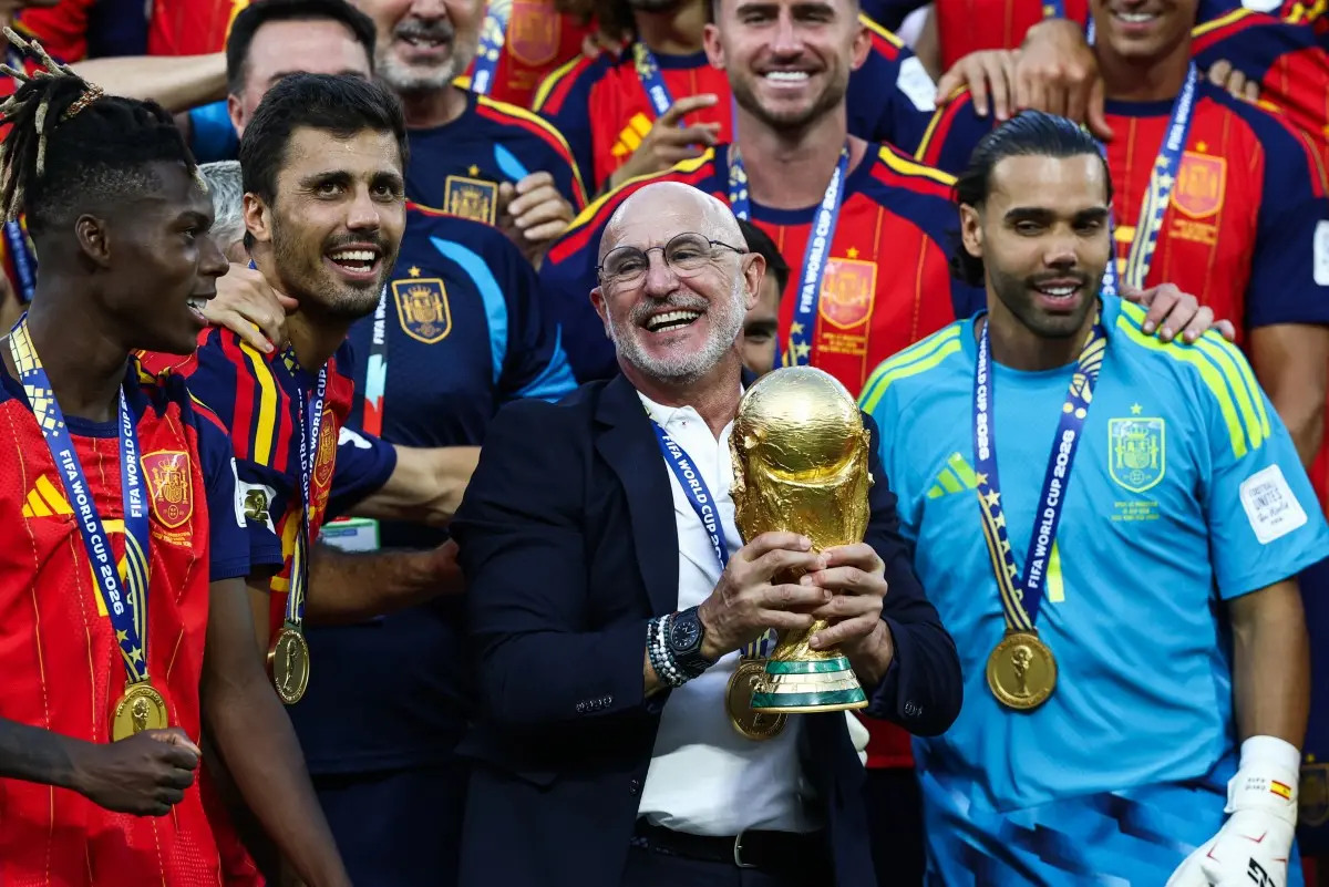 Luis de la Fuente segura o troféu do Campeonato do Mundo de Futebol de 2026 durante a celebração da Espanha com os jogadores.